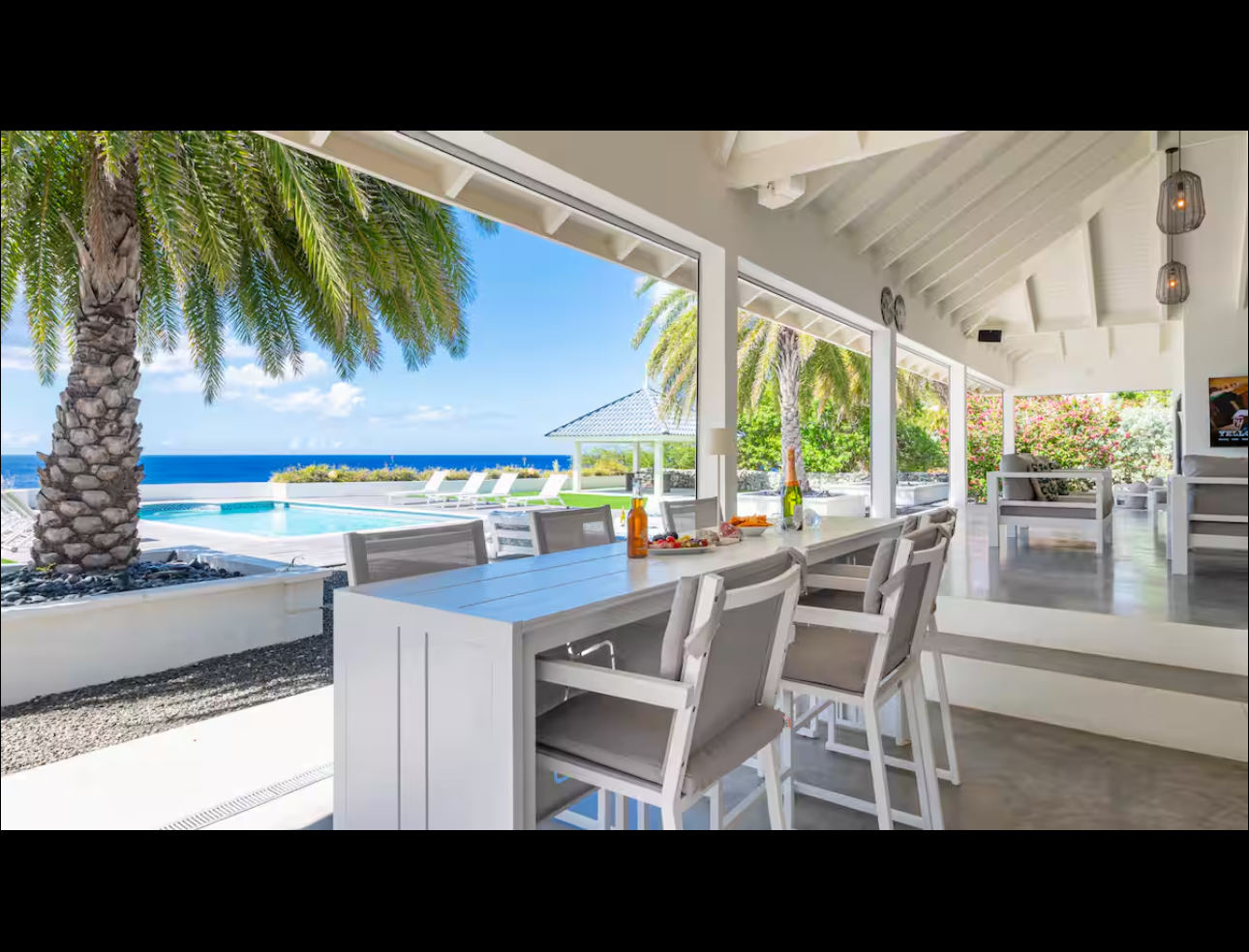 Covered outdoor dining table beside the pool