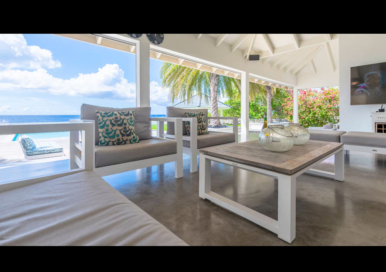 Open-air lounge with turquoise accents and ocean views