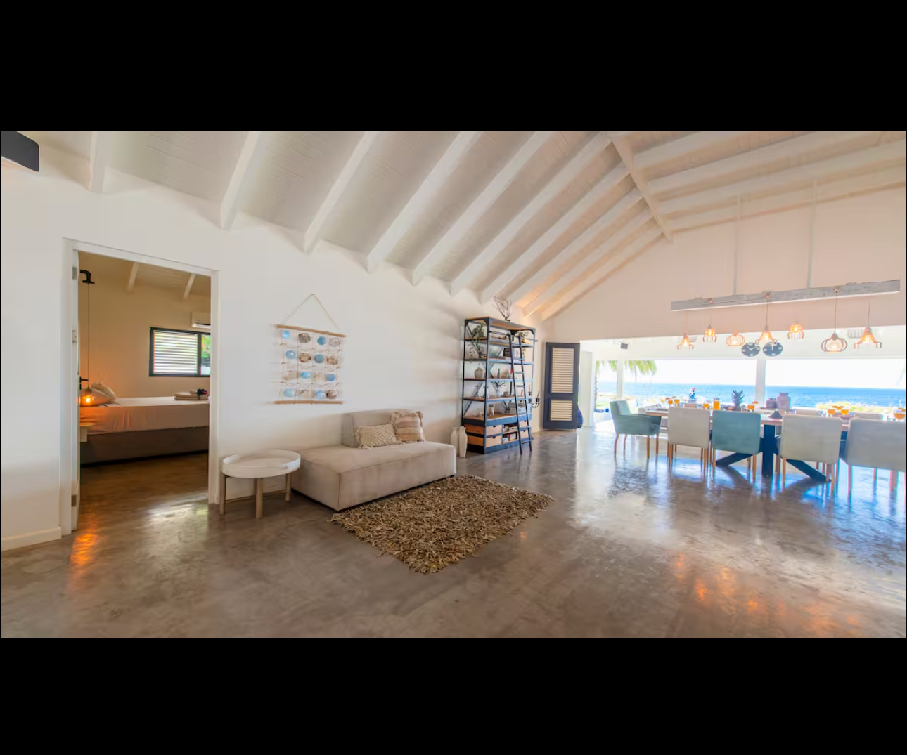 Open-plan lounge and dining room facing the Caribbean Sea